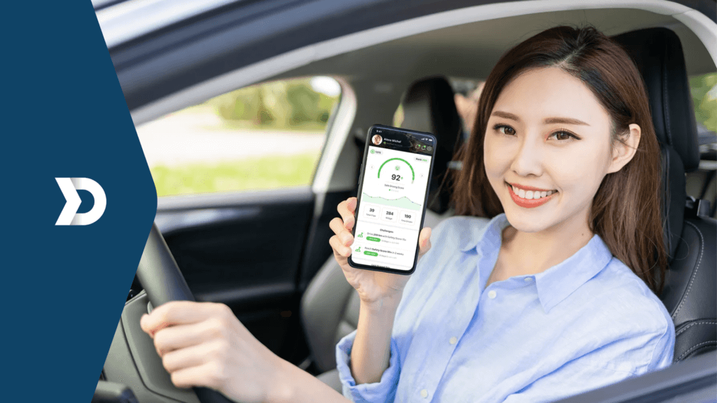 An employee driver with her hand on the stirring wheel shows her driver score in the Zenroad app for safe driving powered by Damoov.