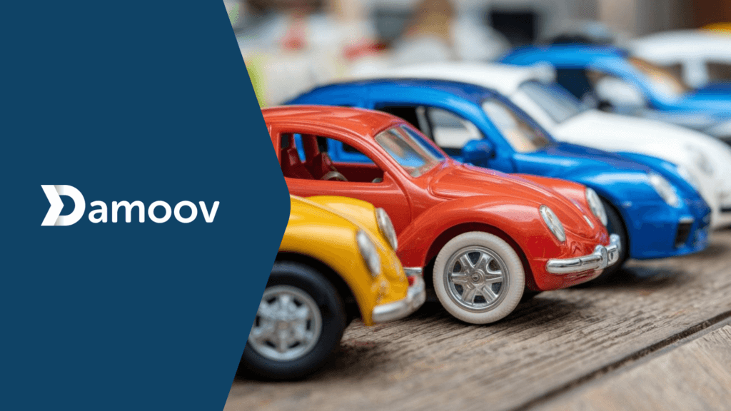A close-up of colorful toy cars lined up on a wooden surface, representing young drivers' vehicles and the potential of Damoov's mobile telematics for personalized insurance premiums.