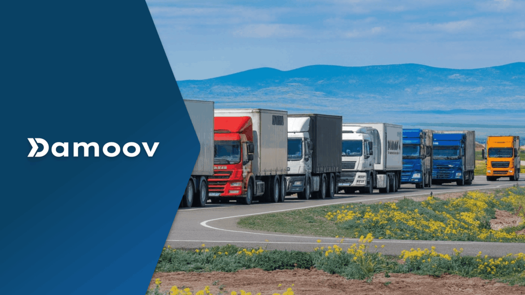 Fleet of colorful cargo trucks driving on a rural highway with mountains in the background, representing mobile telematics solutions for fleet management.