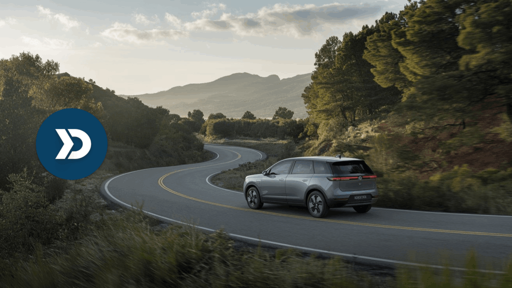 Electric SUV driving through a scenic mountain road, illustrating eco-driving with mobile telematics technology.
