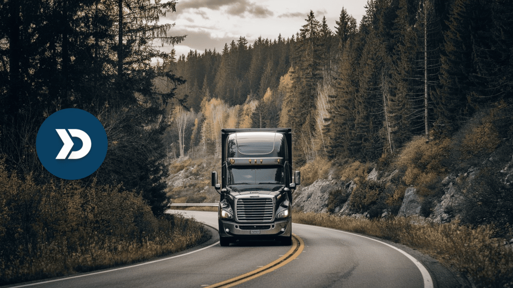 Commercial semi-truck driving on a winding forest road, showcasing mobile telematics for trucking fleet tracking and route optimization