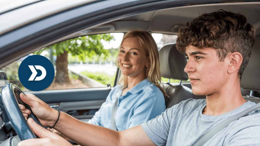Teen driver participating in a Graduated Driver Licensing (GDL) program while using mobile telematics technology to monitor safe driving behavior, with a parent supervising from the passenger seat.
