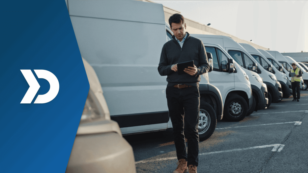 Fleet manager using a tablet to monitor commercial delivery vans equipped with mobile telematics technology for driver safety coaching, fleet tracking, and risk management.