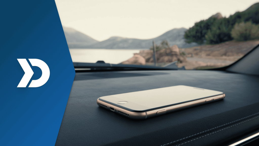 Smartphone on a vehicle dashboard illustrating automatic trip detection using mobile telematics, smartphone sensors, GPS tracking, and AI-powered trip recognition.